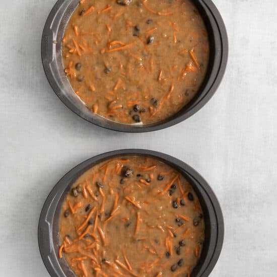 two baking pans filled with carrot cake batter.