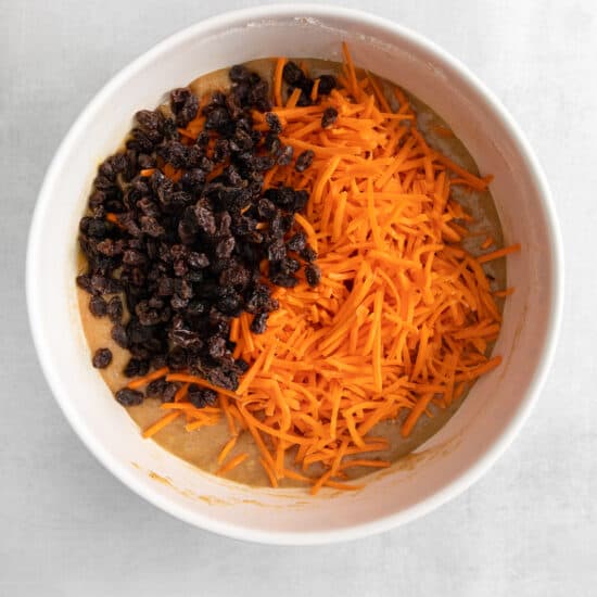 carrots and raisins in a white bowl.