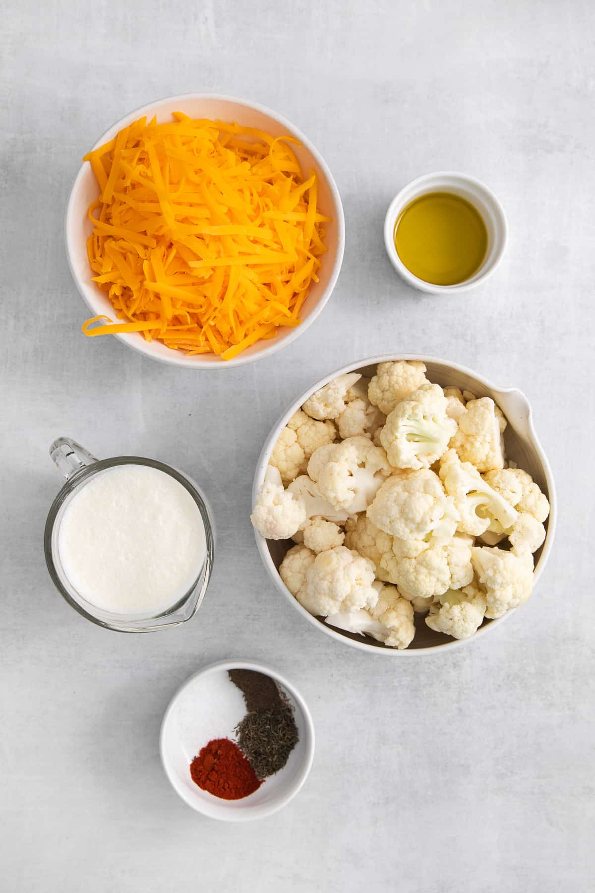 Ingredients for cauliflower mac and cheese in bowls.