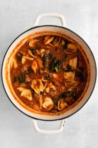a pot of soup with meat and vegetables in it.