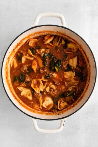 a pot of soup with meat and vegetables in it.