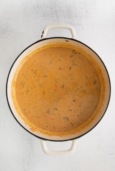 a pot full of soup on a white surface.