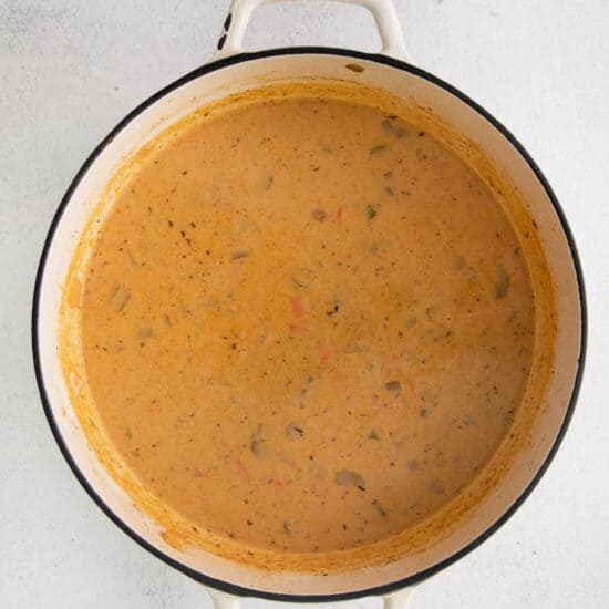 a pot full of soup on a white surface.