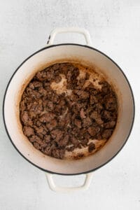a pot with meat in it on a white background.