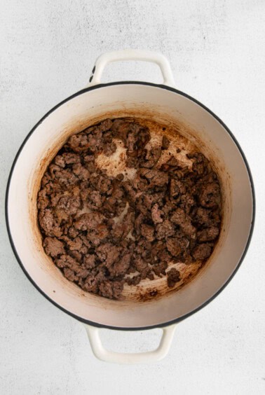 a pot with meat in it on a white background.