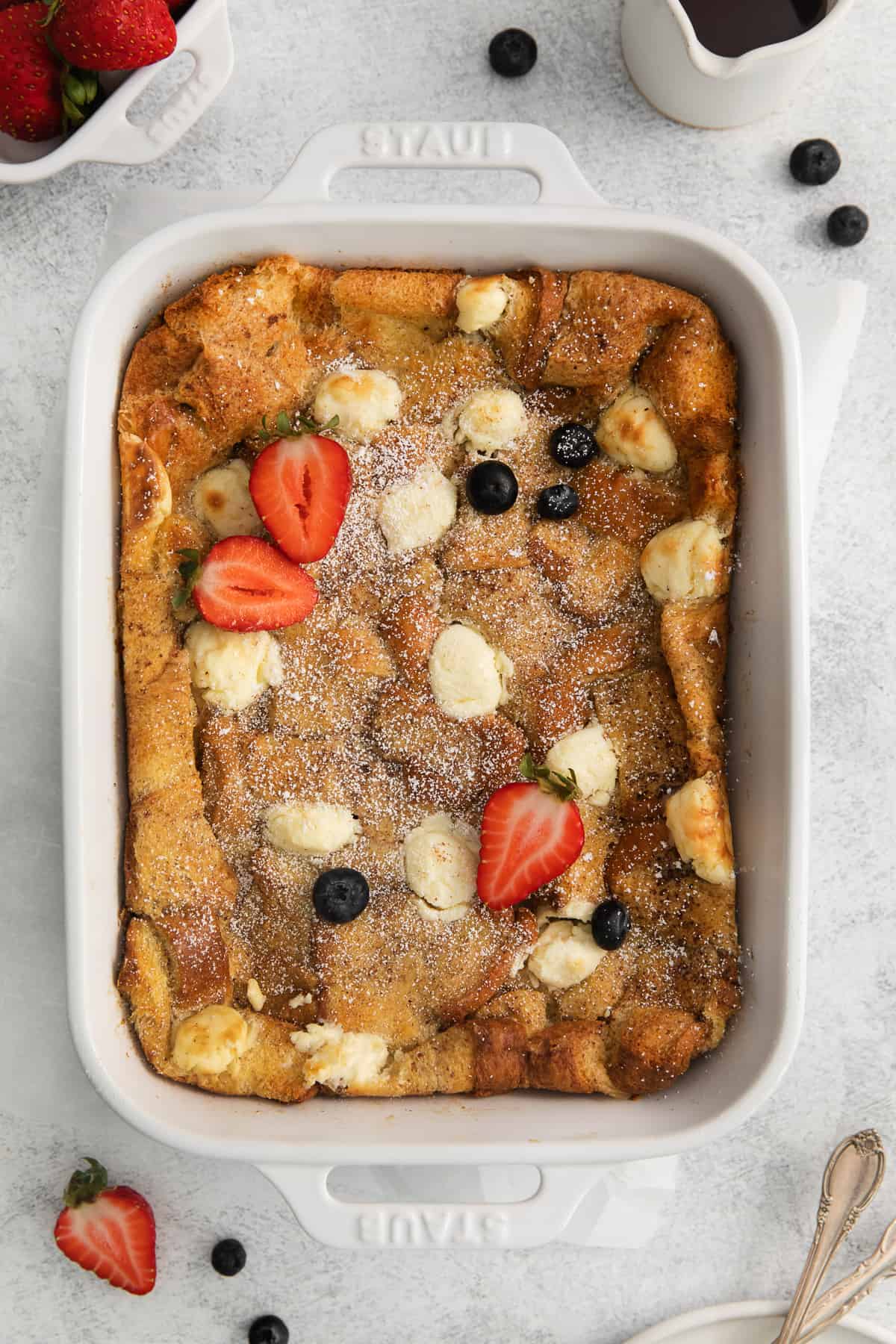 cream cheese french toast casserole with berries on top.