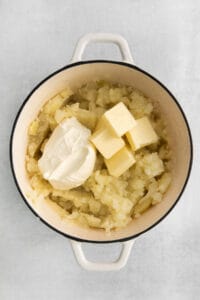 mashed potatoes and butter in a pot.
