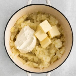 mashed potatoes and butter in a pot.