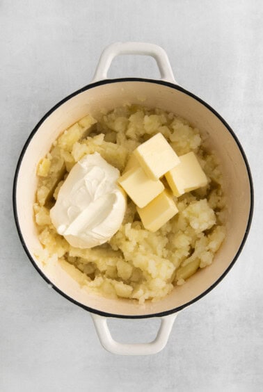 mashed potatoes and butter in a pot.