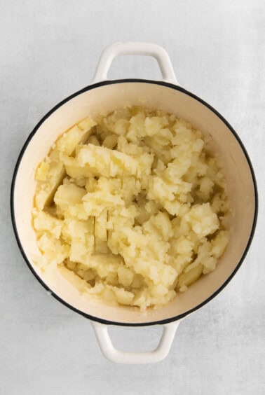 mashed potatoes in a pot on a white background.