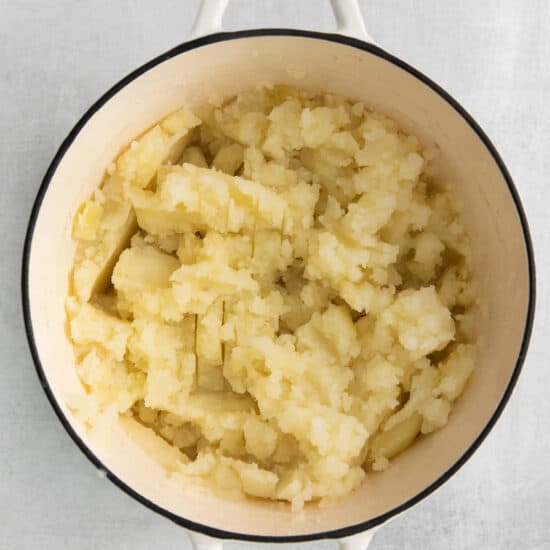mashed potatoes in a pot on a white background.