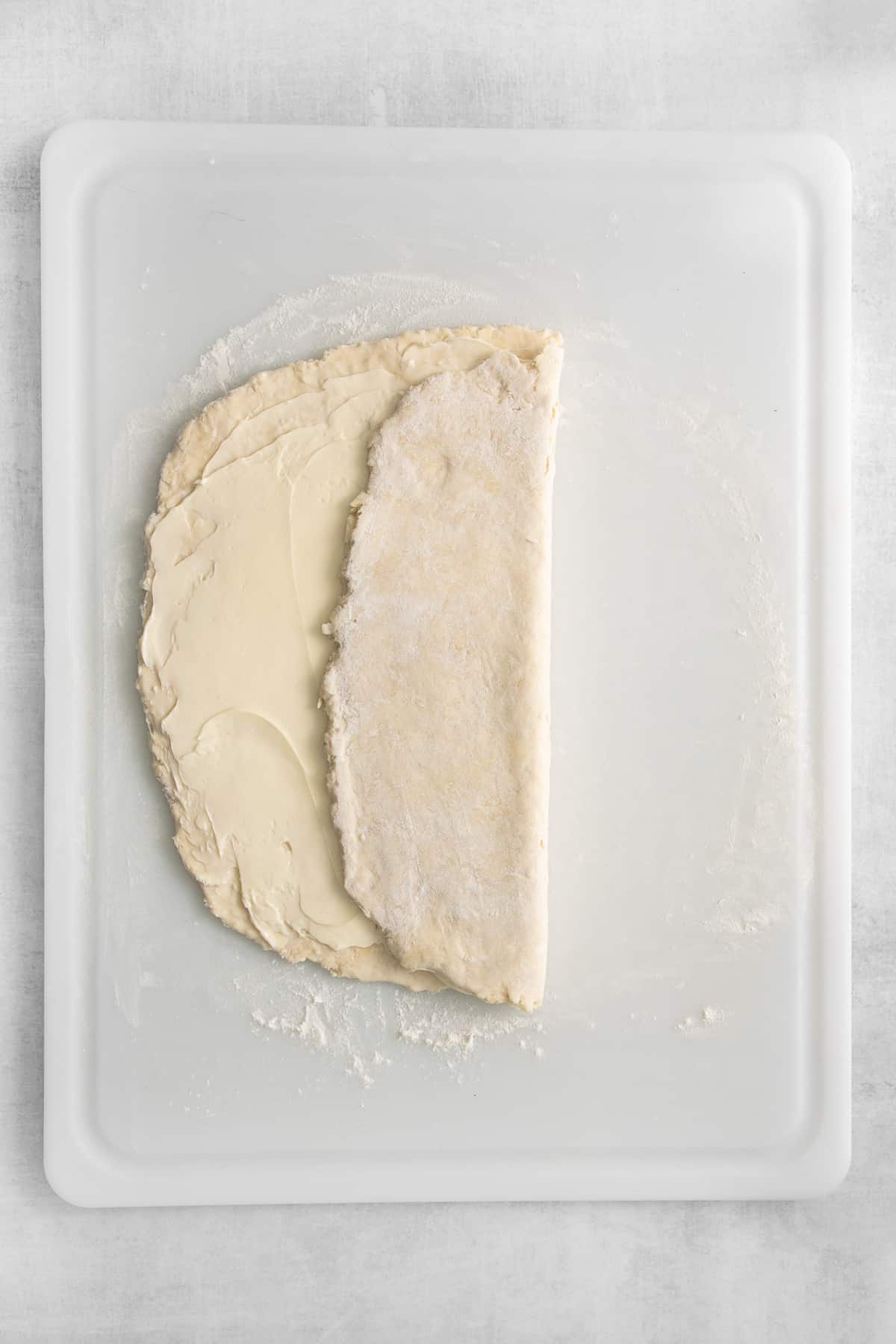 Butter spread on puff pastry dough and folded over it.