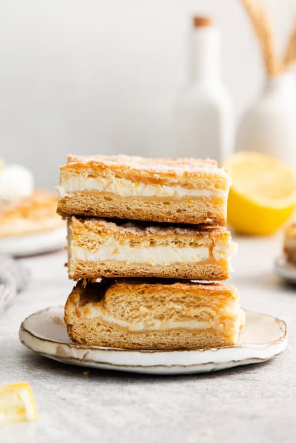 Lemon cream cheese bars stacked 3 high.