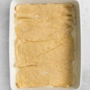 a white baking dish with a piece of bread in it.