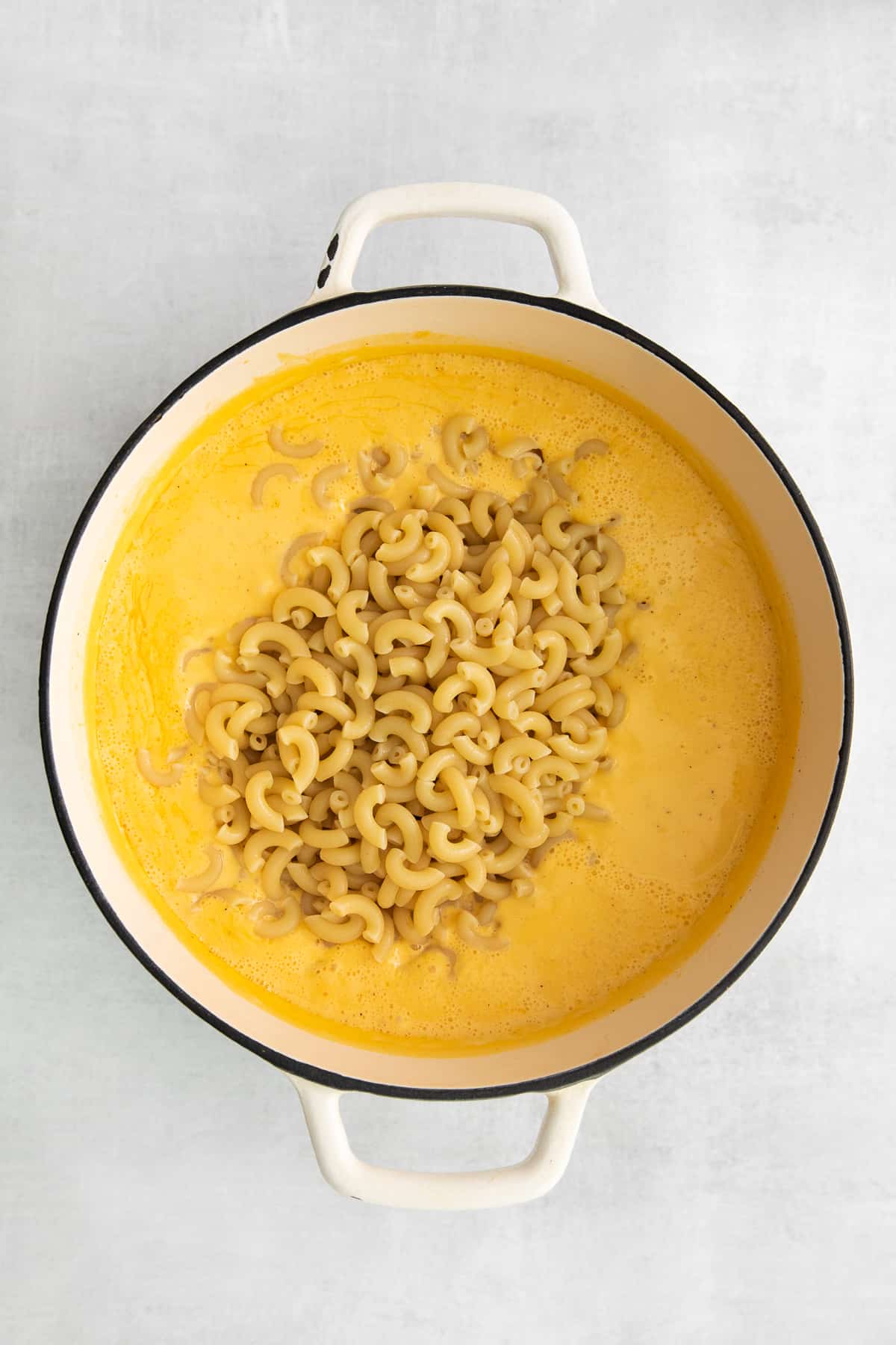 Macaroni noodles in a cheese soup.