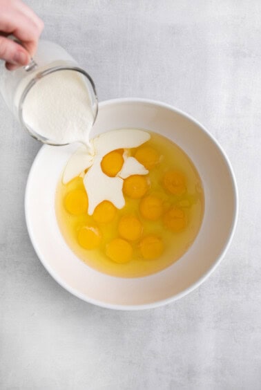 eggs and milk in bowl.