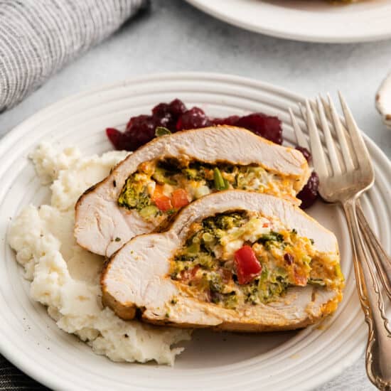 a plate of turkey stuffed with vegetables and mashed potatoes.
