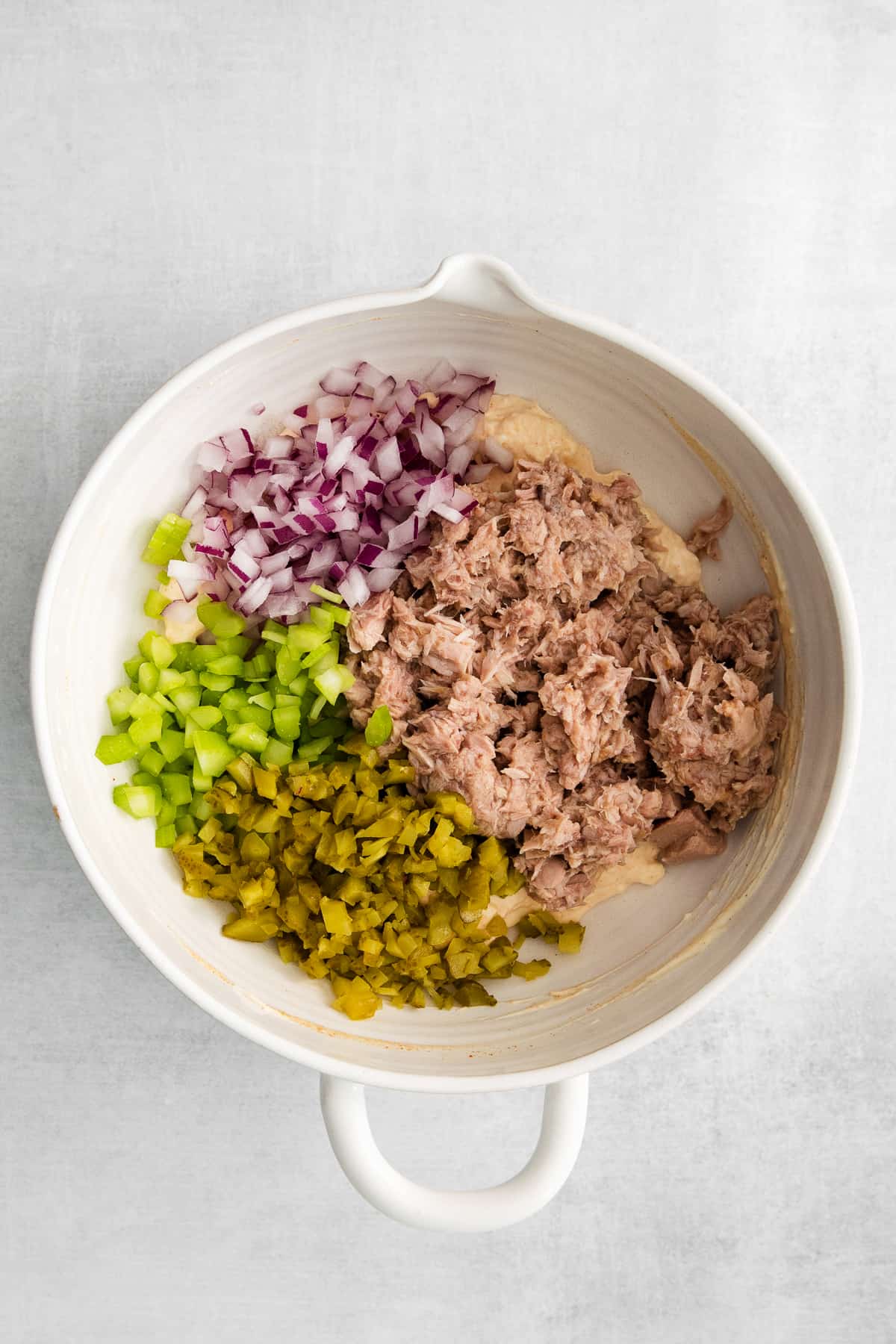tuna salad ingredients in bowl.