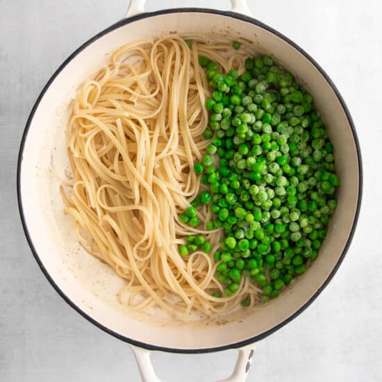adding peas and noodles to pot.
