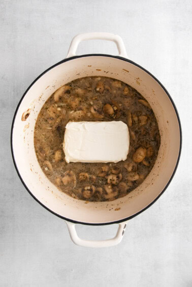 adding cream cheese to sauce.