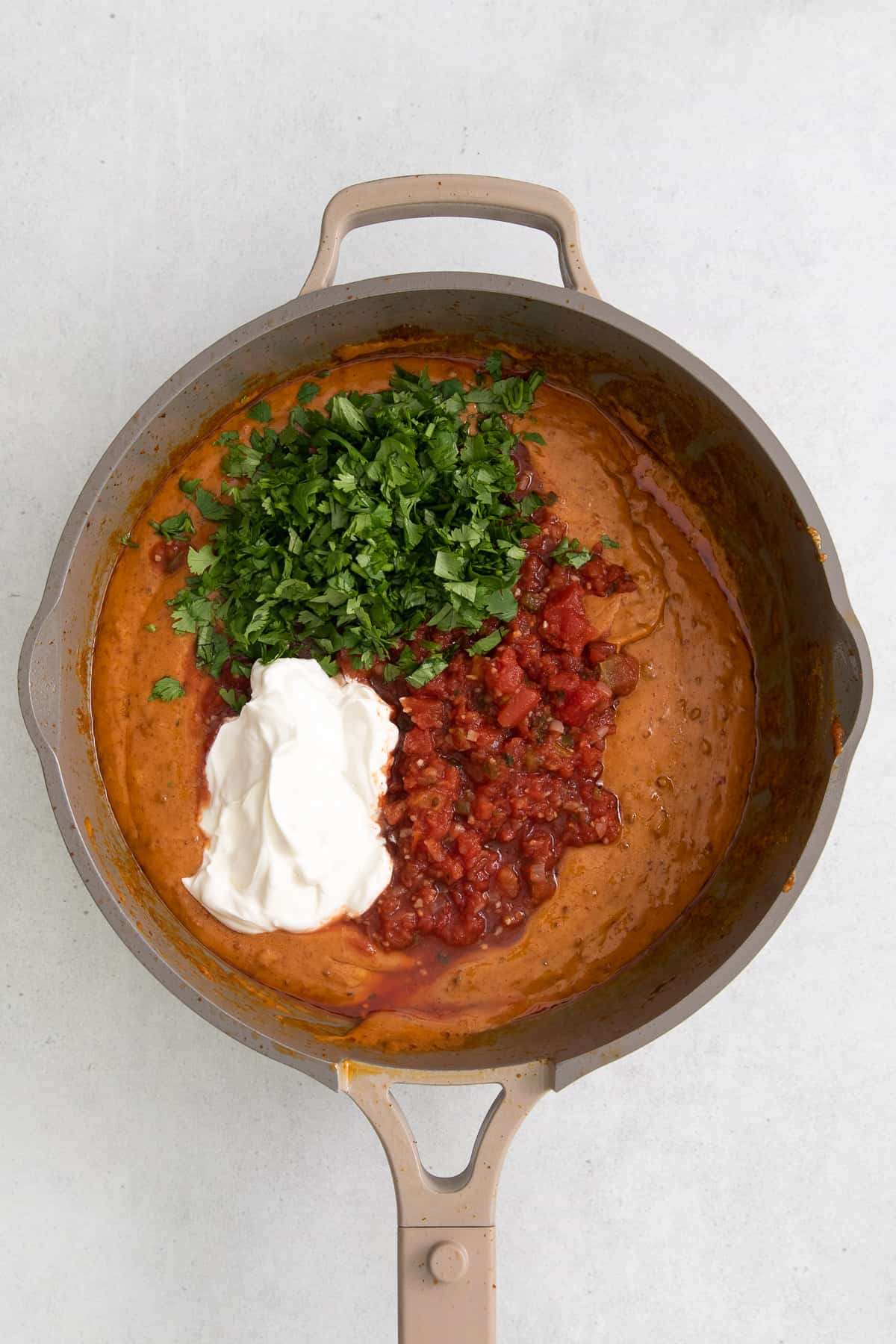 adding ingredients to dip in pan.