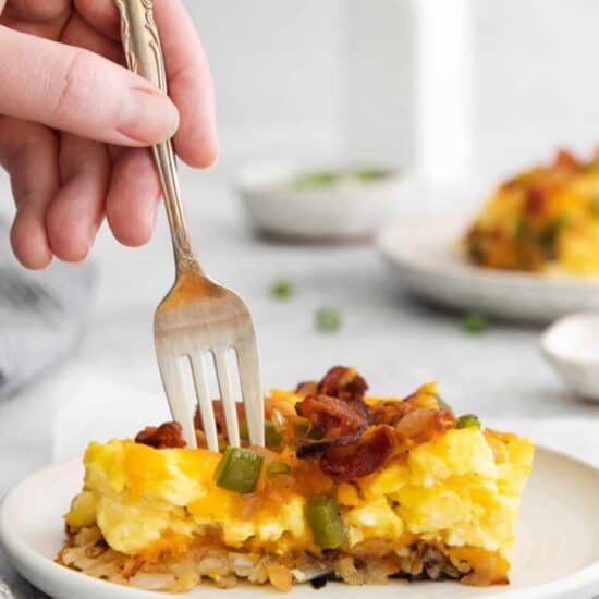 Slice of breakfast pizza on a plate.