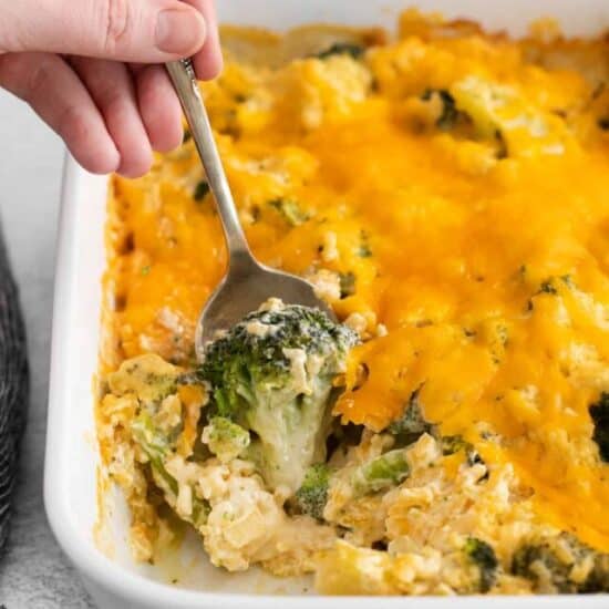 Broccoli cheese casserole on a spoon.