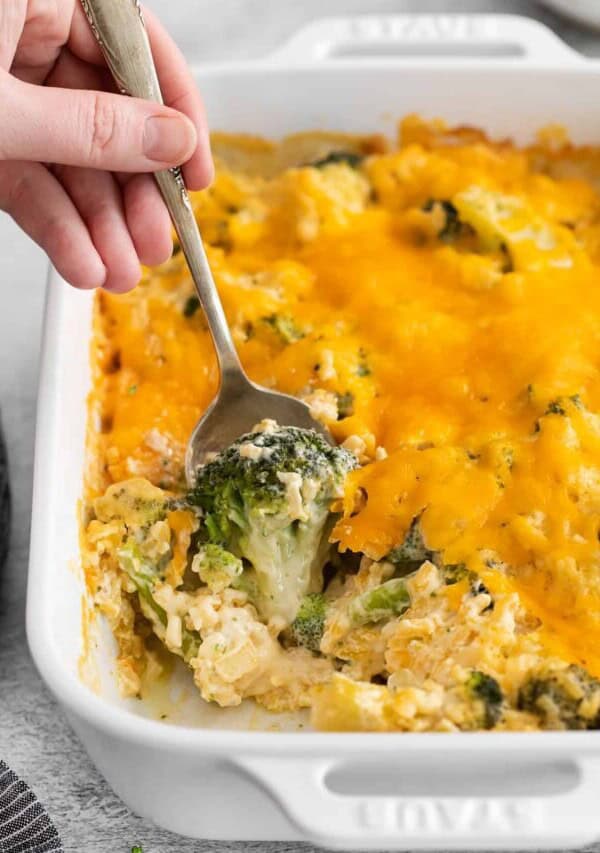 Broccoli cheese casserole on a spoon.