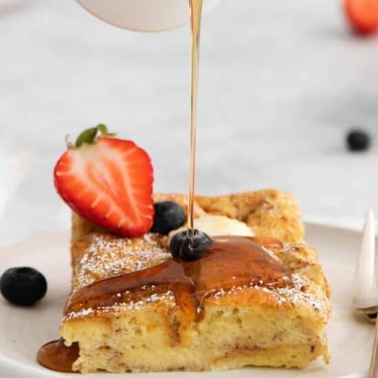 cream cheese french toast bake with syrup being poured on top