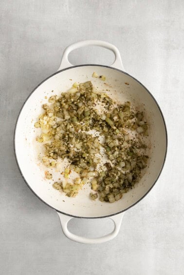 a pan with onions and garlic in it.