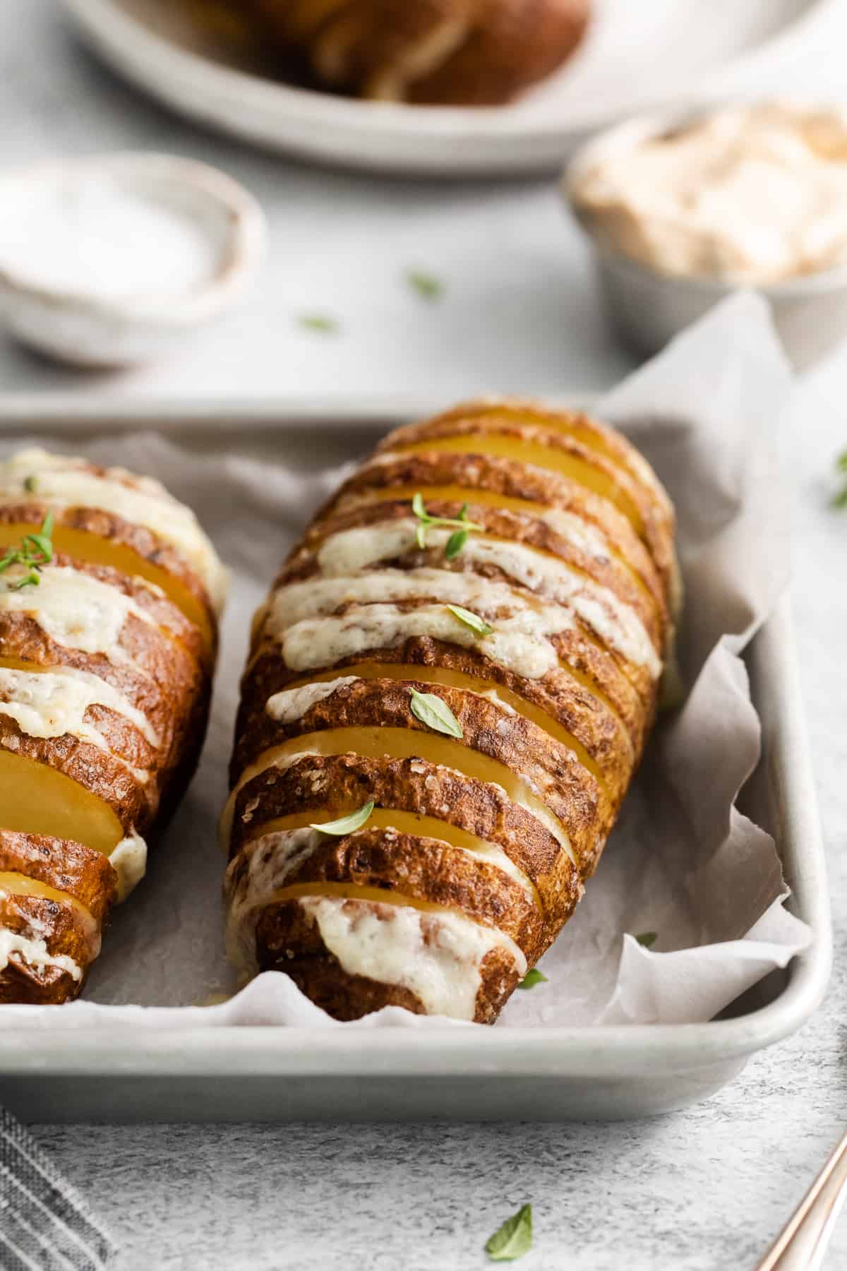 Hasselback potatoes on a plate.