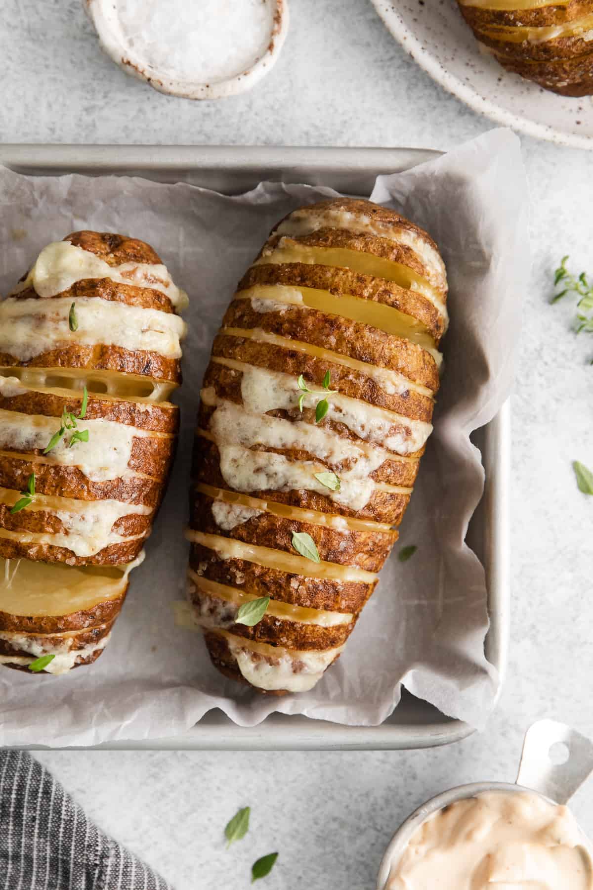 Hasselback potatoes on a baking sheet.