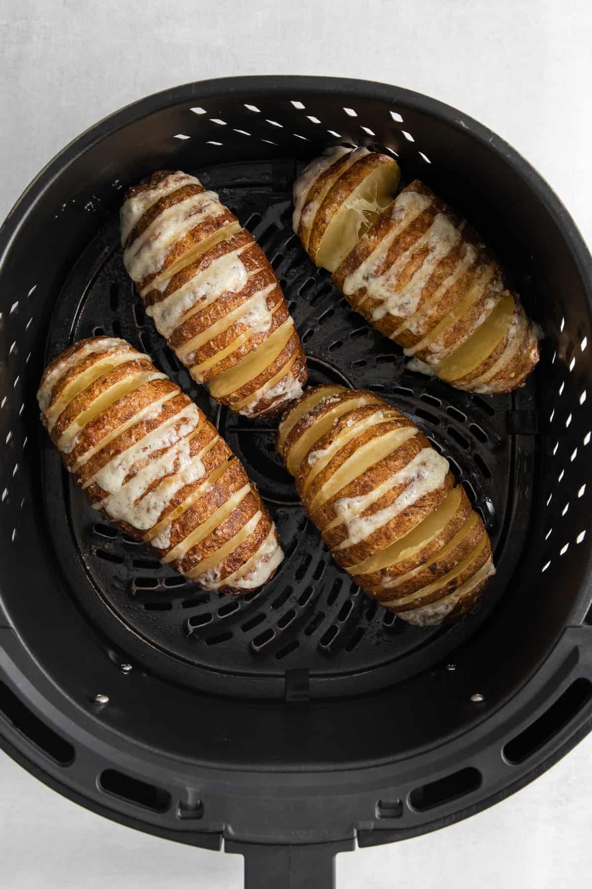 Air fryer hasselback potatoes in an air fryer.