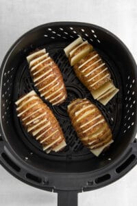 a black grill with sliced potatoes in it.