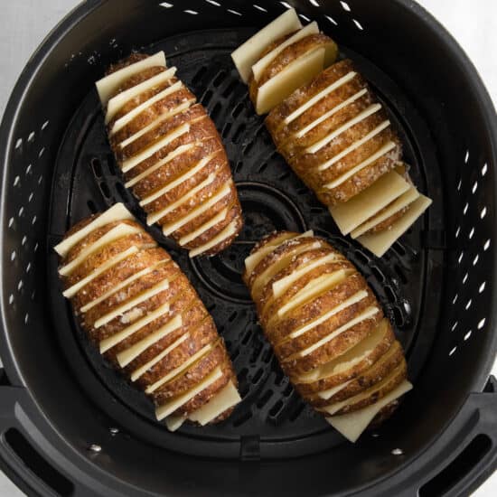 a black grill with sliced potatoes in it.