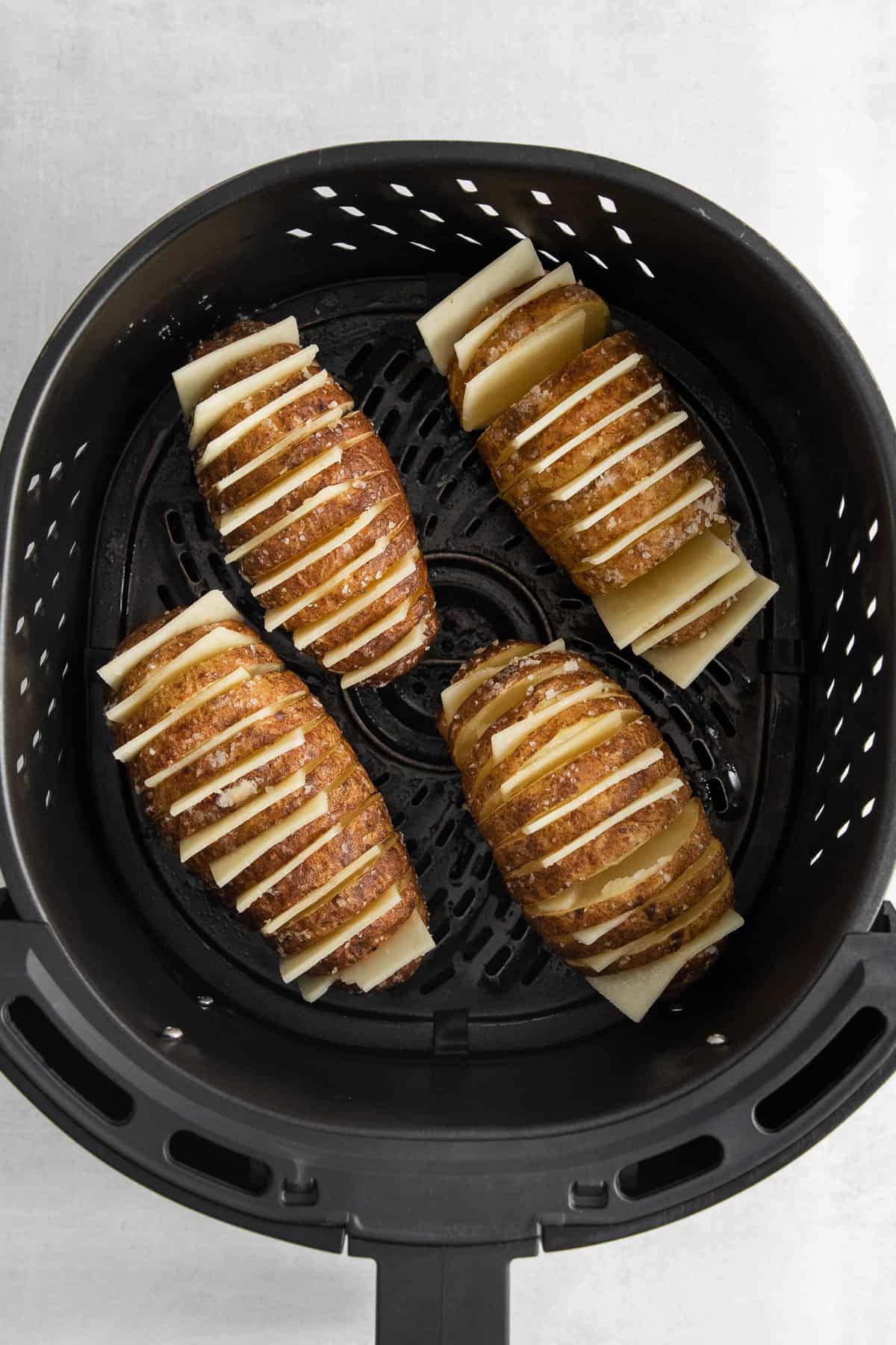 Hasselback potatoes stuffed with cheese in an air fryer.