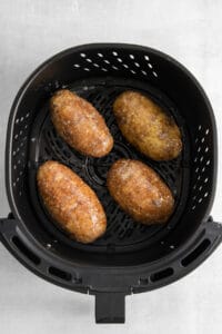 four fried potatoes in an air fryer.