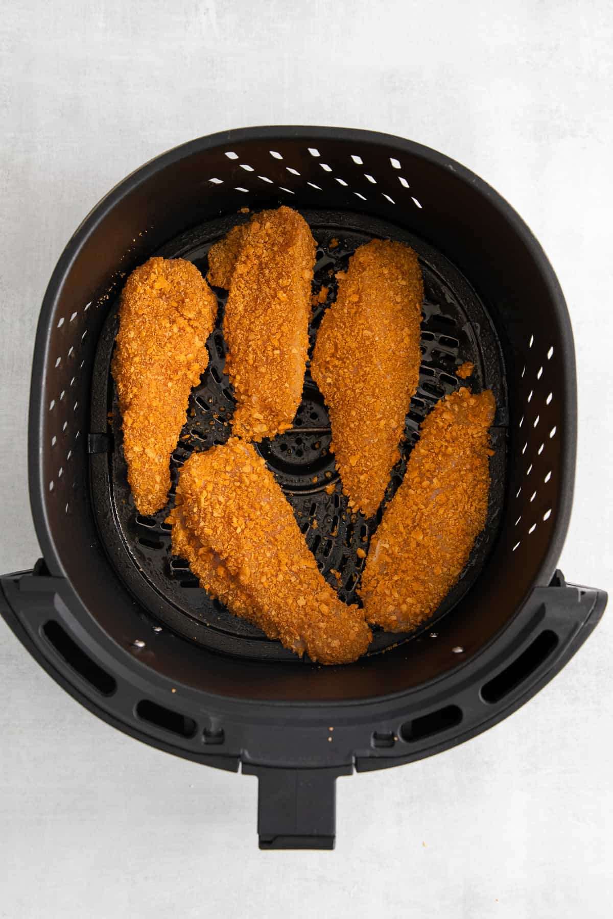 Cheez-it breaded chicken fingers in an air fryer.