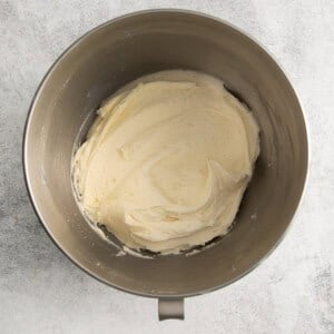 whipped cream in a metal mixing bowl.