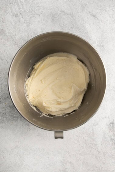 whipped cream in a metal mixing bowl.