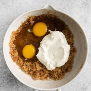 two eggs and whipped cream in a white bowl.