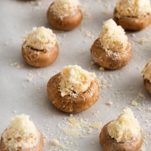 cheesy stuffed mushrooms on a baking sheet.