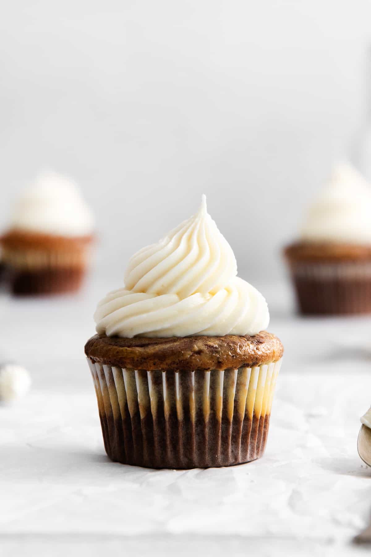 Cream cheese buttercream frosting on a cupcake.