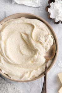 whipped cream in a bowl with a spoon.