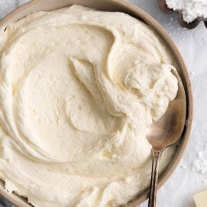 whipped cream in a bowl with a spoon.