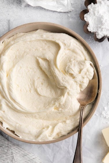 whipped cream in a bowl with a spoon.