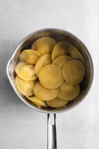 cooked ravioli in pot.