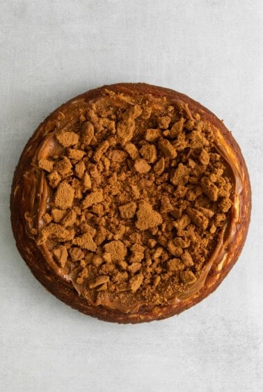 a cake with a crumb topping on a white background.