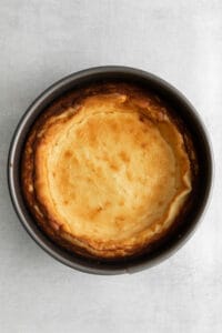 a cheesecake in a pan on a white background.