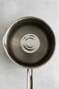 a stainless steel frying pan with a lid.